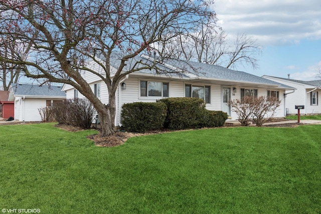 single story home with a front lawn and roof with shingles