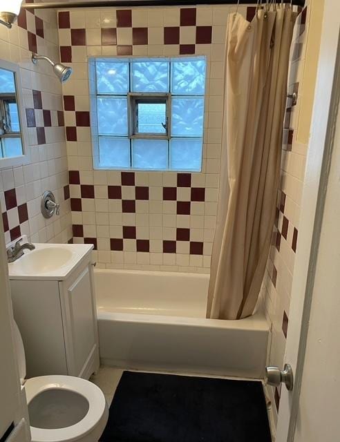 full bathroom featuring vanity, shower / tub combo with curtain, and toilet