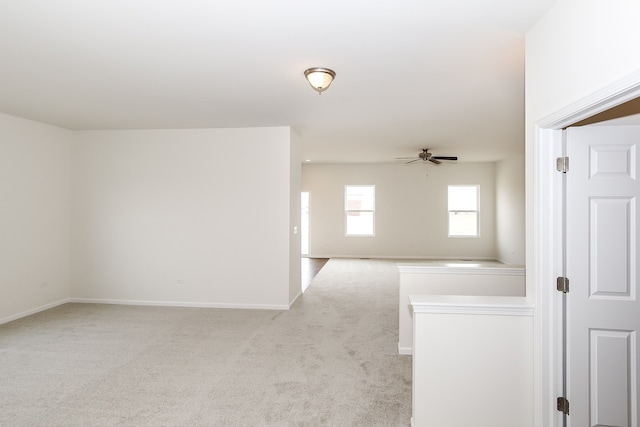 unfurnished room with ceiling fan and light colored carpet