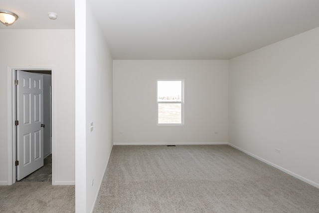 spare room with light carpet