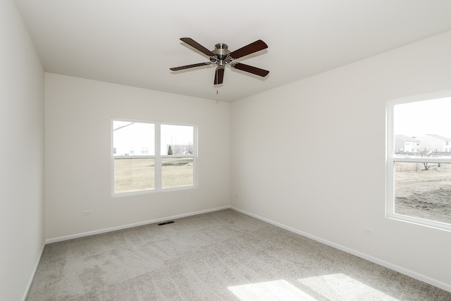 carpeted empty room with ceiling fan