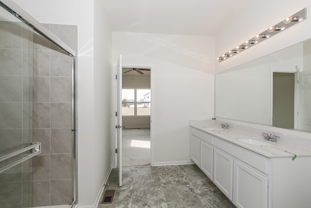 bathroom featuring a shower with door, vanity, and ceiling fan