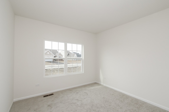 spare room with light colored carpet