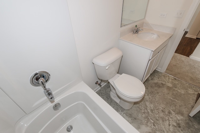 bathroom featuring vanity, toilet, and a washtub