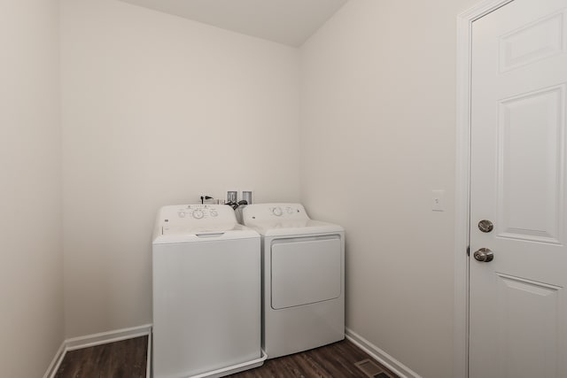 laundry room featuring separate washer and dryer and dark hardwood / wood-style floors