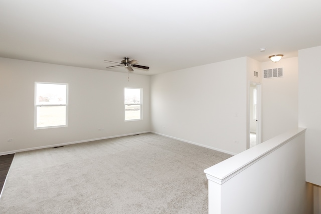 unfurnished room with ceiling fan and carpet floors