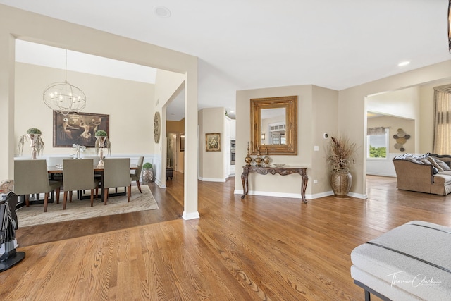 living room with hardwood / wood-style flooring and an inviting chandelier