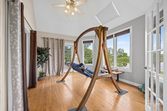 exercise room with light hardwood / wood-style flooring and french doors