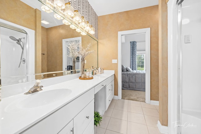 bathroom featuring tile patterned flooring, vanity, and a chandelier