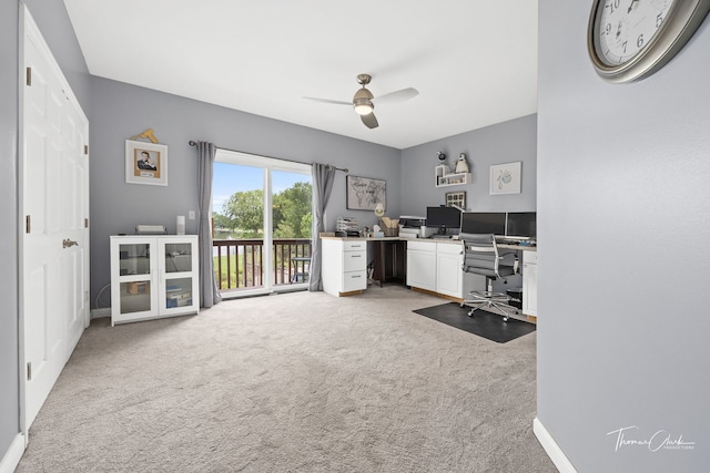 carpeted office featuring ceiling fan