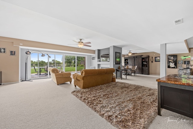 living room featuring light colored carpet and ceiling fan