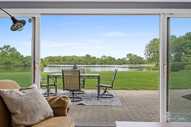 interior space with plenty of natural light and a water view