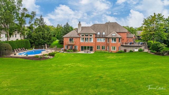 rear view of house with a yard and a patio area