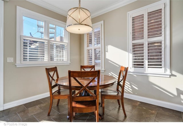 dining space with ornamental molding