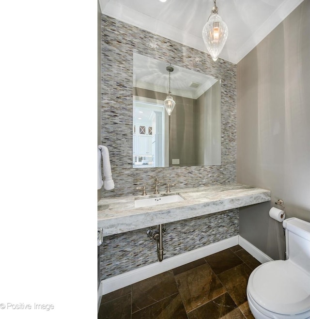 bathroom featuring ornamental molding, sink, decorative backsplash, and toilet