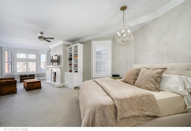 bedroom with crown molding, ceiling fan with notable chandelier, and carpet