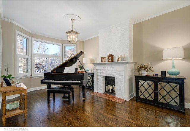 misc room with ornamental molding, dark hardwood / wood-style floors, an inviting chandelier, and a fireplace