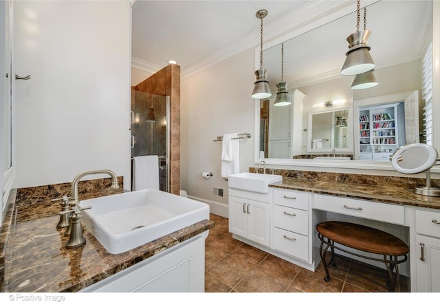 bathroom featuring an enclosed shower, vanity, and ornamental molding