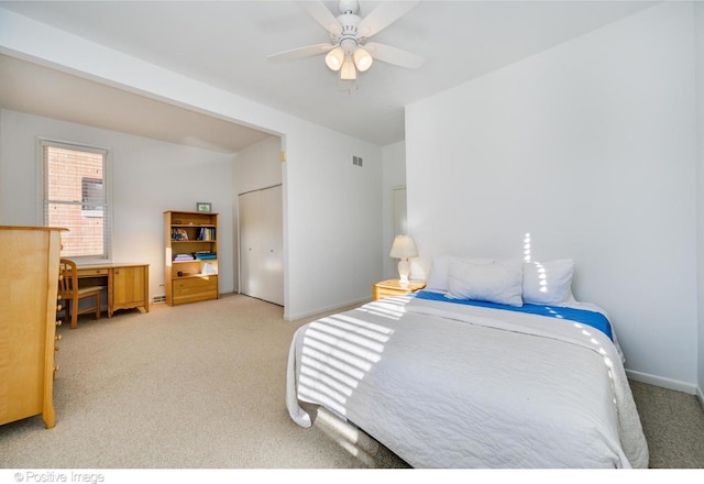 carpeted bedroom featuring a closet and ceiling fan