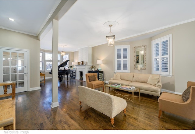 living room featuring ornamental molding, dark hardwood / wood-style floors, and a brick fireplace