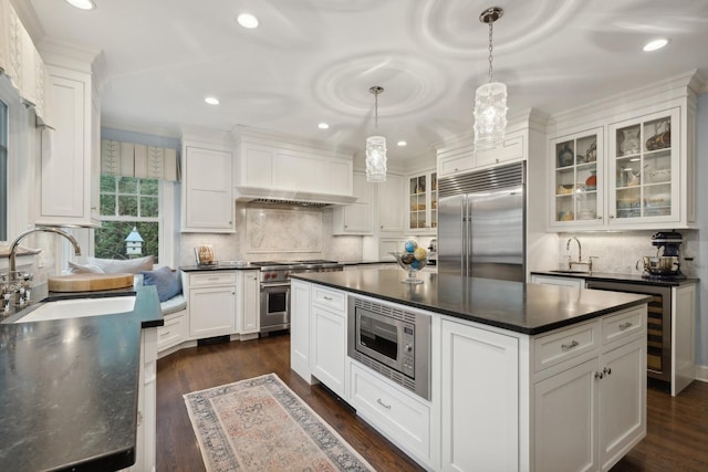 621 E Prospect Ave, Lake Bluff, IL 60044 - kitchen featuring built in appliances, dark countertops, a sink, white cabinetry, and recessed lighting