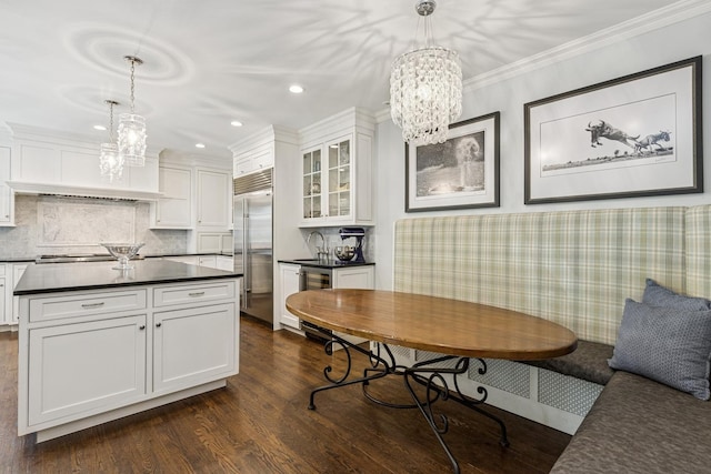 621 E Prospect Ave, Lake Bluff, IL 60044 - kitchen with a chandelier, stainless steel appliances, dark countertops, white cabinets, and dark wood-type flooring