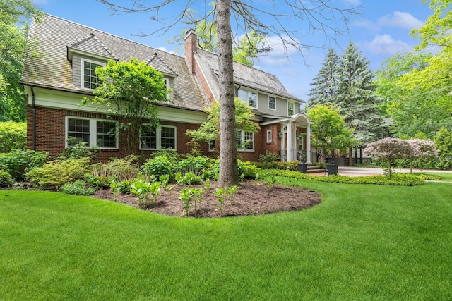 621 E Prospect Ave, Lake Bluff, IL 60044 - view of front of property featuring brick siding, a front yard, and a chimney