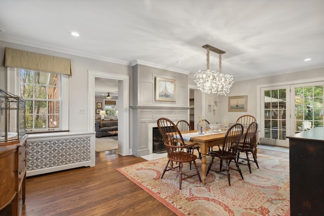 621 E Prospect Ave, Lake Bluff, IL 60044 - dining area featuring ornamental molding, wood finished floors, a fireplace with flush hearth, a chandelier, and recessed lighting