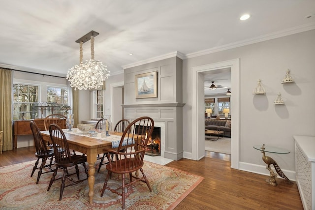 621 E Prospect Ave, Lake Bluff, IL 60044 - dining room with healthy amount of natural light, crown molding, wood finished floors, a fireplace with flush hearth, and baseboards