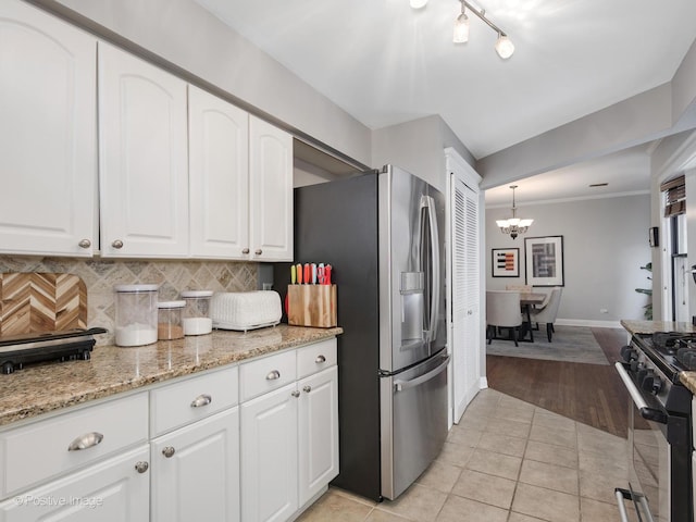 kitchen featuring white cabinetry and range with gas stovetop