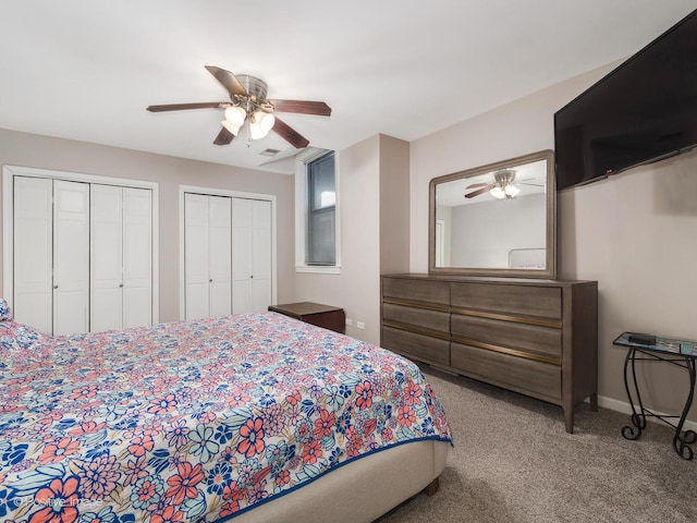 bedroom featuring multiple closets, ceiling fan, and carpet flooring