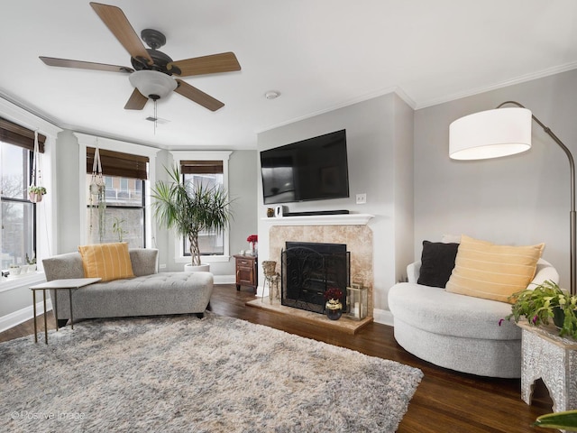 living room with crown molding, dark hardwood / wood-style floors, and ceiling fan