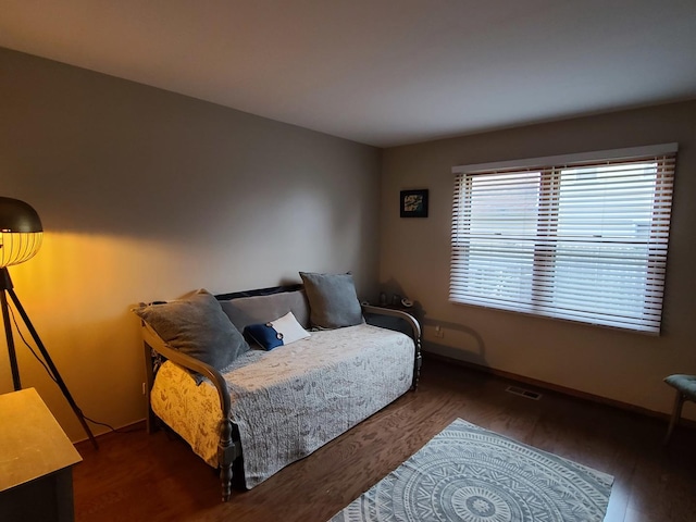 bedroom with dark wood-type flooring