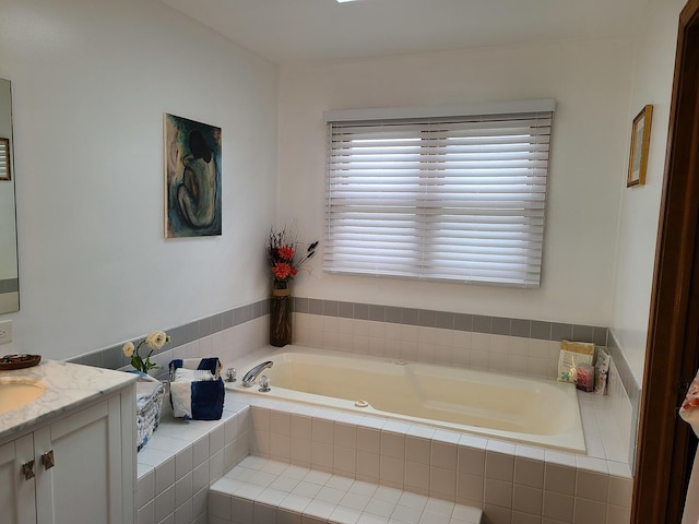 bathroom featuring vanity and tiled bath