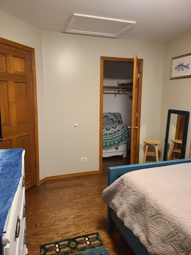 bedroom featuring dark hardwood / wood-style flooring and a closet