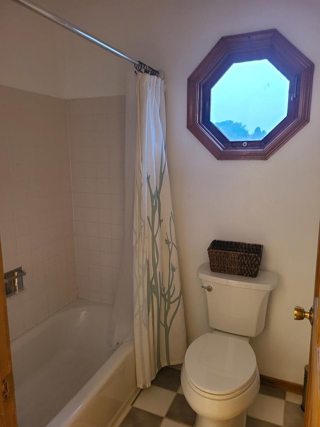 bathroom featuring shower / tub combo and toilet