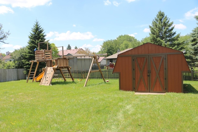 view of play area featuring a yard and a shed