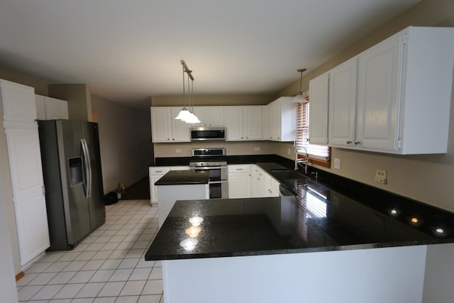 kitchen featuring white cabinetry, appliances with stainless steel finishes, sink, and a kitchen island