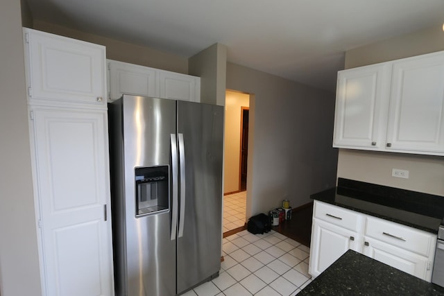 kitchen featuring stainless steel fridge with ice dispenser, light tile patterned floors, and white cabinets