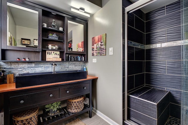 bathroom featuring vanity and a tile shower