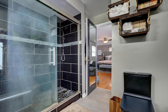 bathroom with hardwood / wood-style flooring and walk in shower