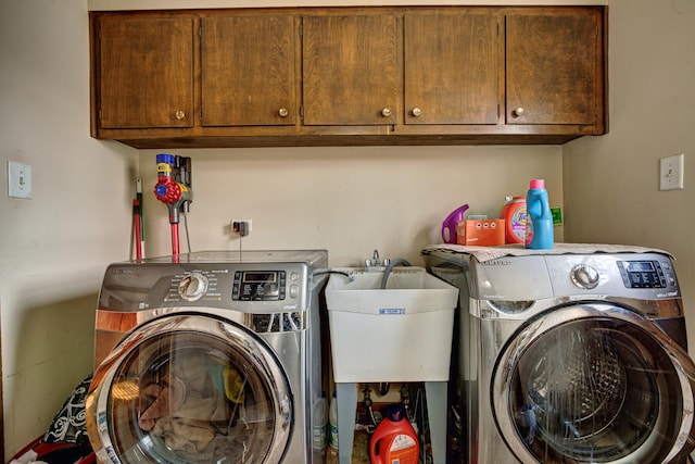 washroom with independent washer and dryer, cabinets, and sink