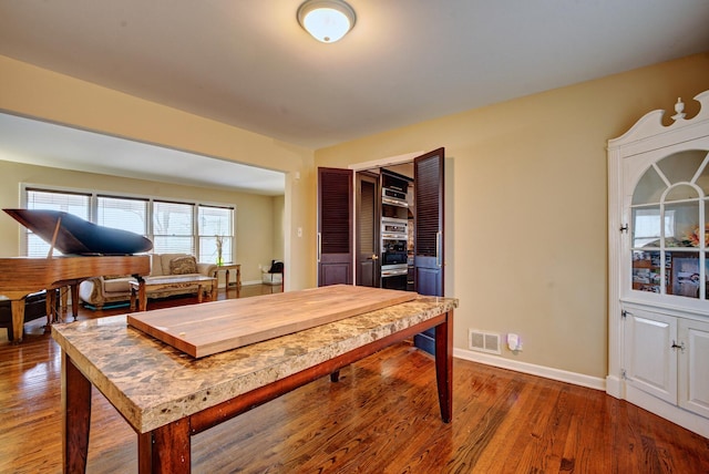 dining space with hardwood / wood-style floors