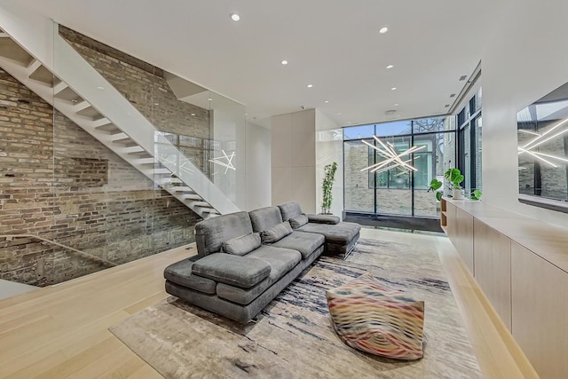 living room with recessed lighting, expansive windows, and light wood finished floors