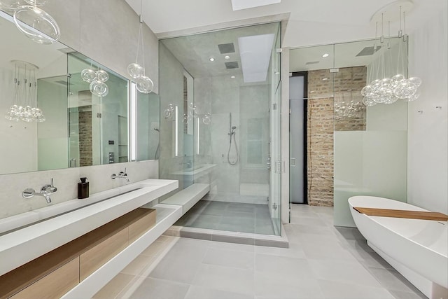 bathroom featuring vanity, a soaking tub, and a shower stall