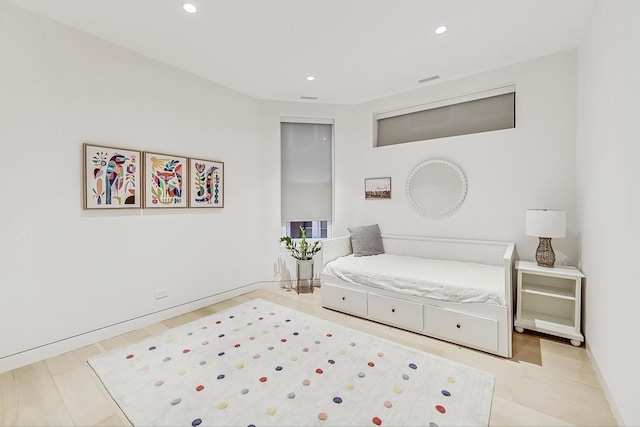 bedroom featuring wood finished floors, recessed lighting, and baseboards