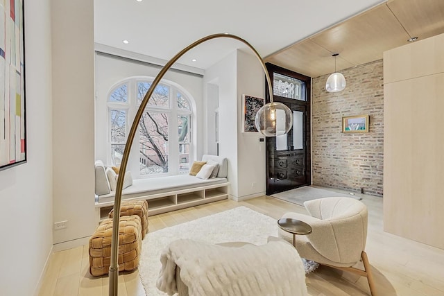 interior space featuring recessed lighting, brick wall, and wood finished floors