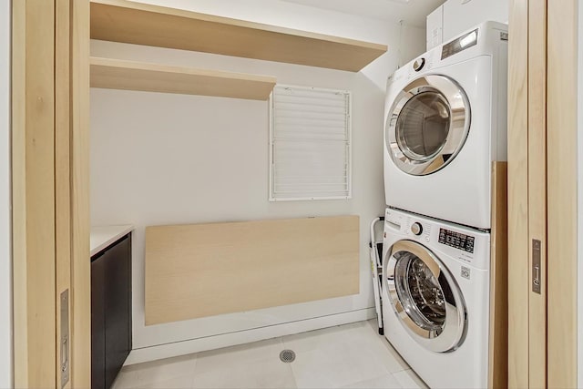 clothes washing area with laundry area and stacked washer and dryer