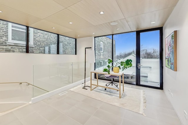 office area with tile patterned floors, recessed lighting, baseboards, and expansive windows