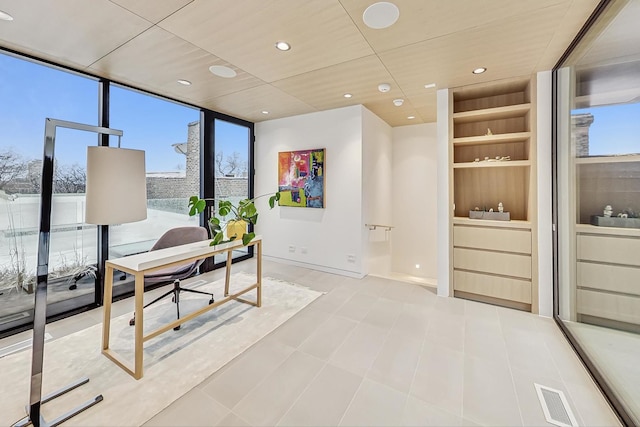 tiled home office with visible vents, built in shelves, expansive windows, recessed lighting, and baseboards